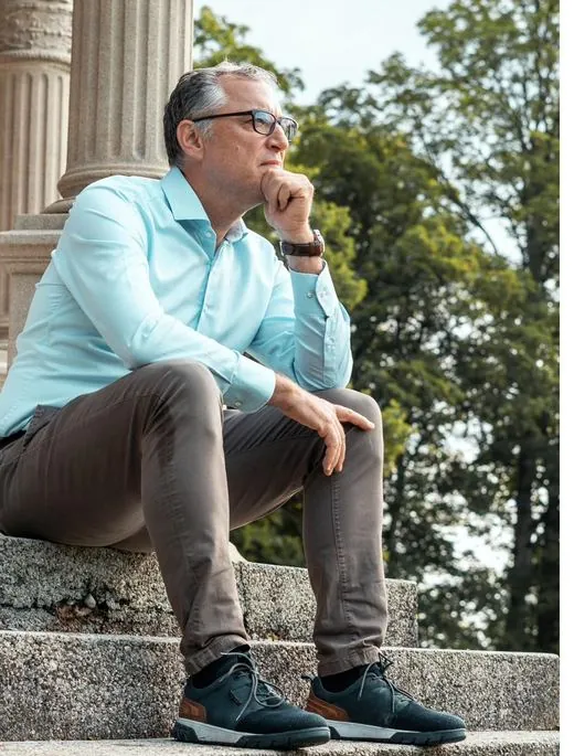 Sebastian Morgner sitting thoughtfully on a flight of steps