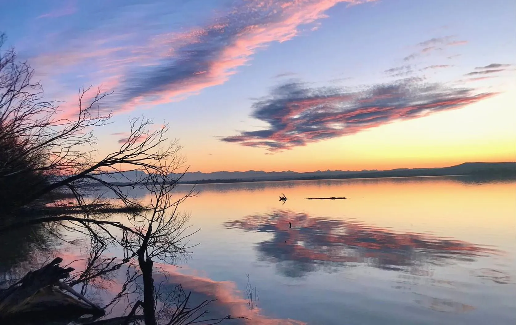 Wide view across Lake Ammersee to the Alps on the horizon